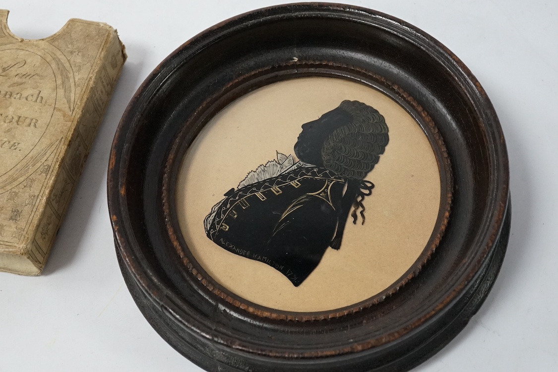 An 1813 Napoleonic Almanack and a reverse glass painted portrait silhouette, 1791, 15cm in diameter. Condition - fair/good